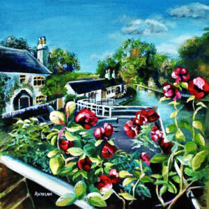View from Foxton Locks bridge including the canal, trees, bridge, house and shop with roses in the foreground.
